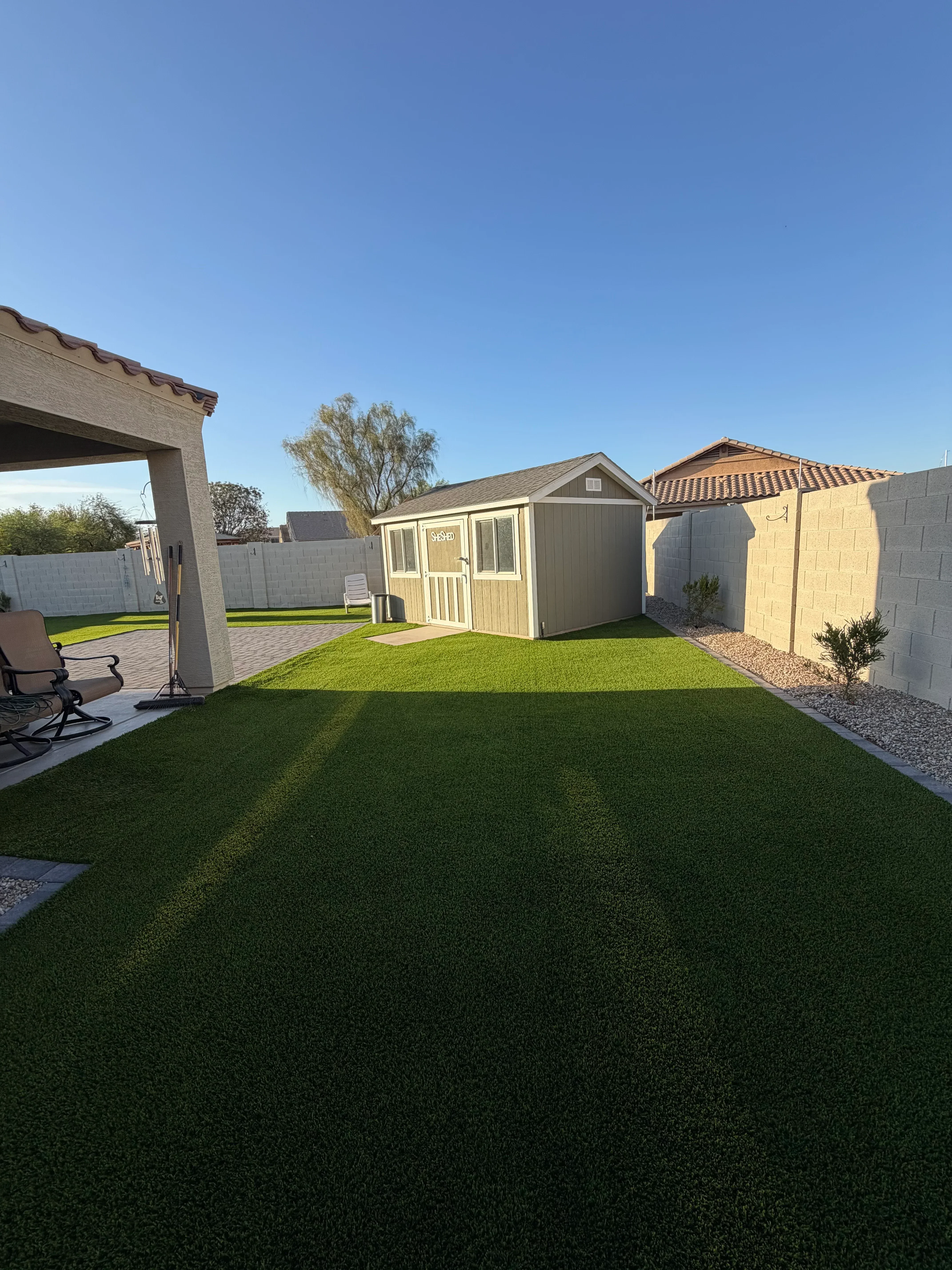 Fresh sod lawn installation with paver edging and residential hardscape design