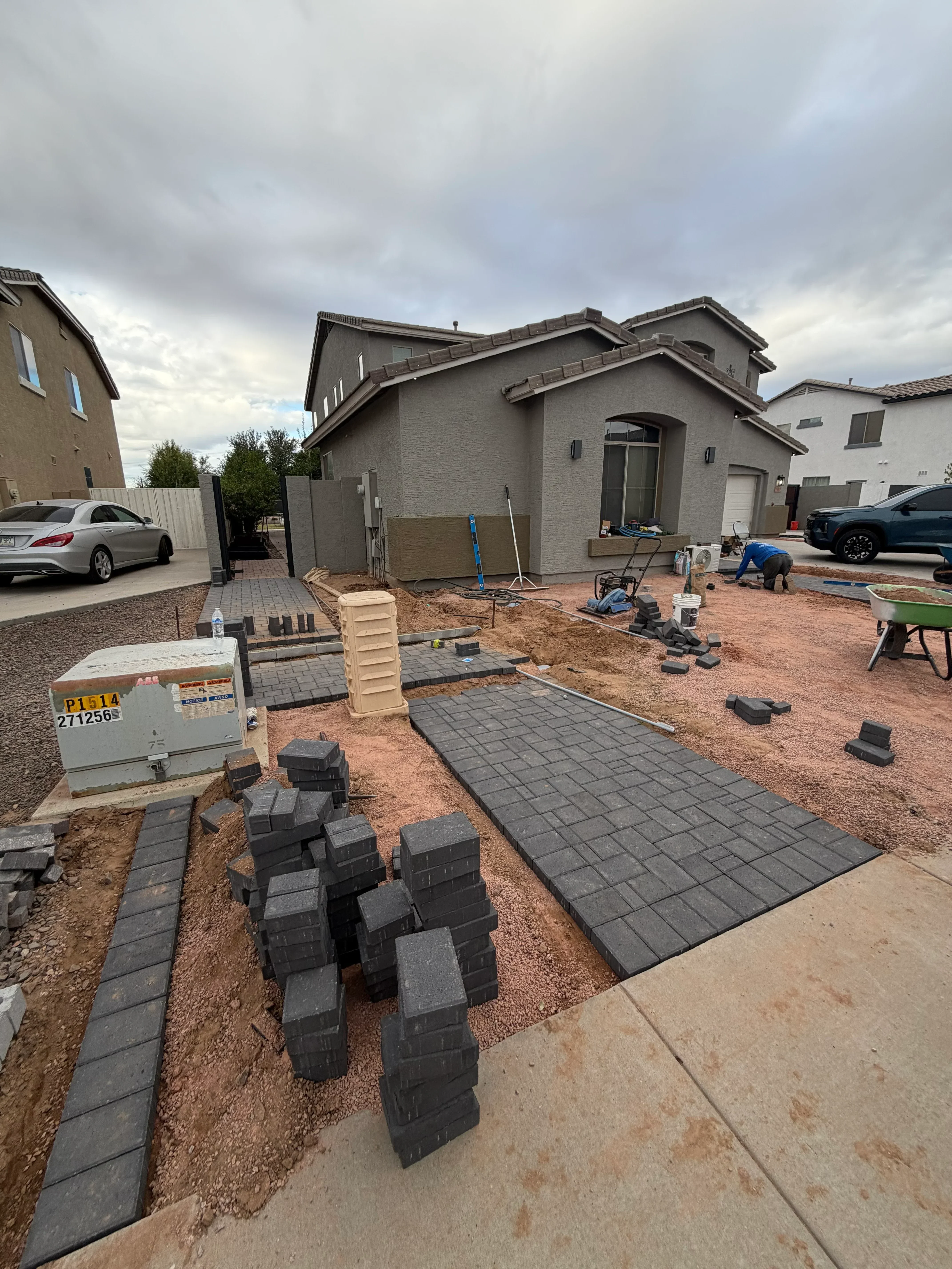 Geometric paver hardscape installation with compacted base and permeable pavers in residential front yard